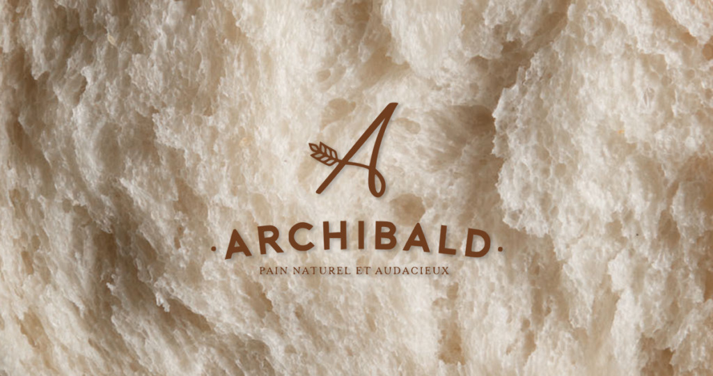 Site marchand d’Archibald réalisé par Divinemenciel : pain de campagne artisanal en gros plan, lumière chaude, texture authentique et savoir-faire boulanger.